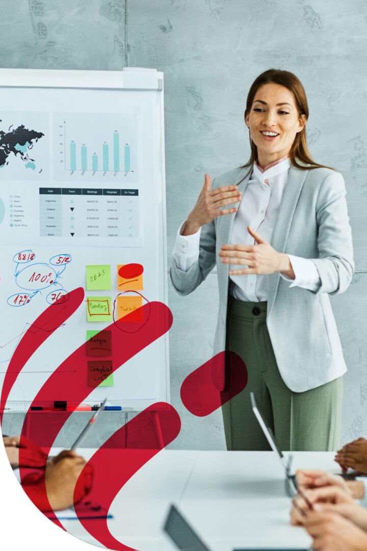Businesswoman presenting data charts in a meeting room.