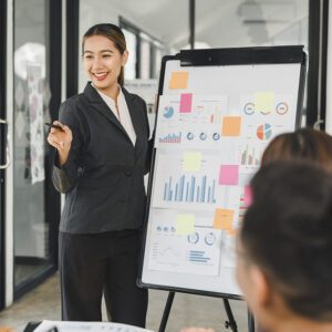 Woman presenting data on flip chart.