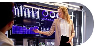 A businesswoman interacting with futuristic digital charts on a transparent screen.