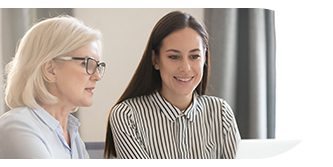 Two women engaged in a discussion, one smiling.