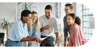 A diverse group collaborating happily around a table in an office.