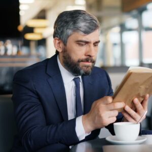 Businessman reading a tablet in a cafe.