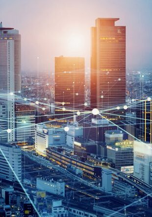 Futuristic cityscape with glowing digital network connections overlay.