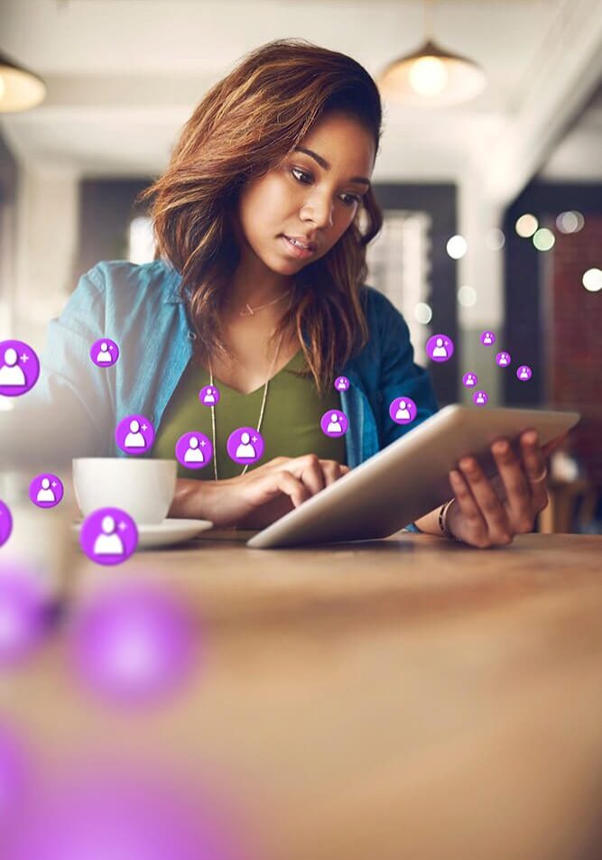 Woman engaging with social media on a tablet.