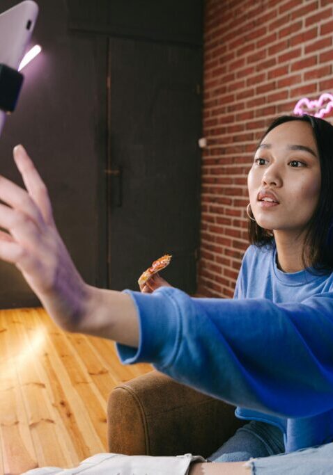 Woman taking a selfie while sitting indoors.