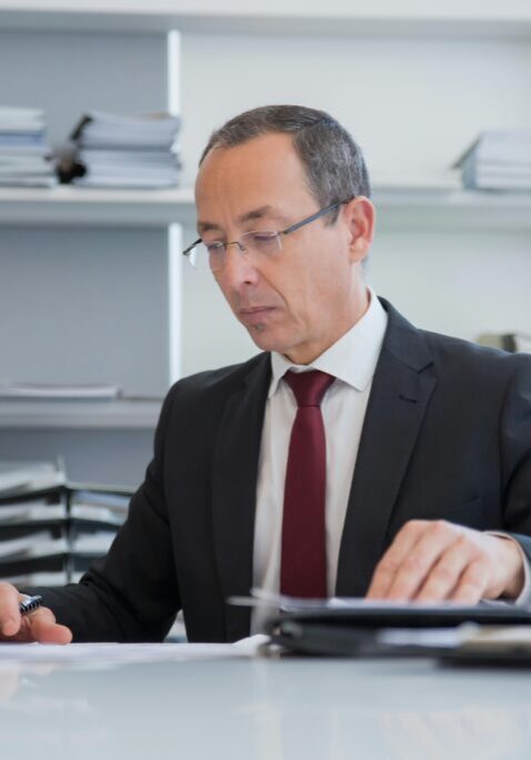 A businessman reviewing documents in an office.