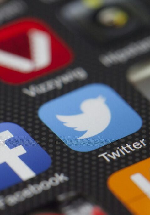 Close-up of social media app icons on a smartphone screen.