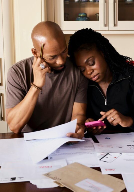 Couple reviewing financial documents together at home.